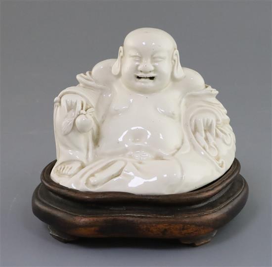 A Chinese blanc-de-chine figure of Budai, 19th century, H. 14cm including hongmu stand
